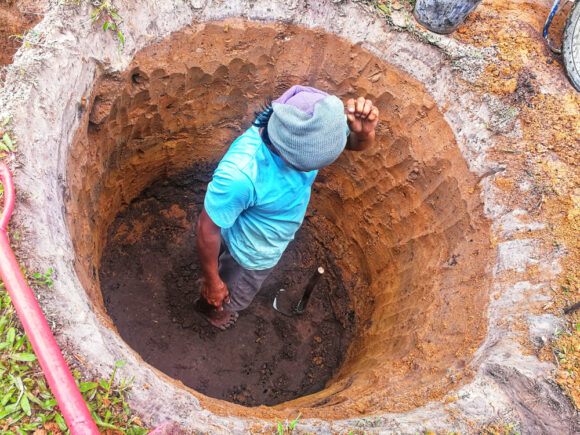 Man,digging,a,hole,for,septic,tank